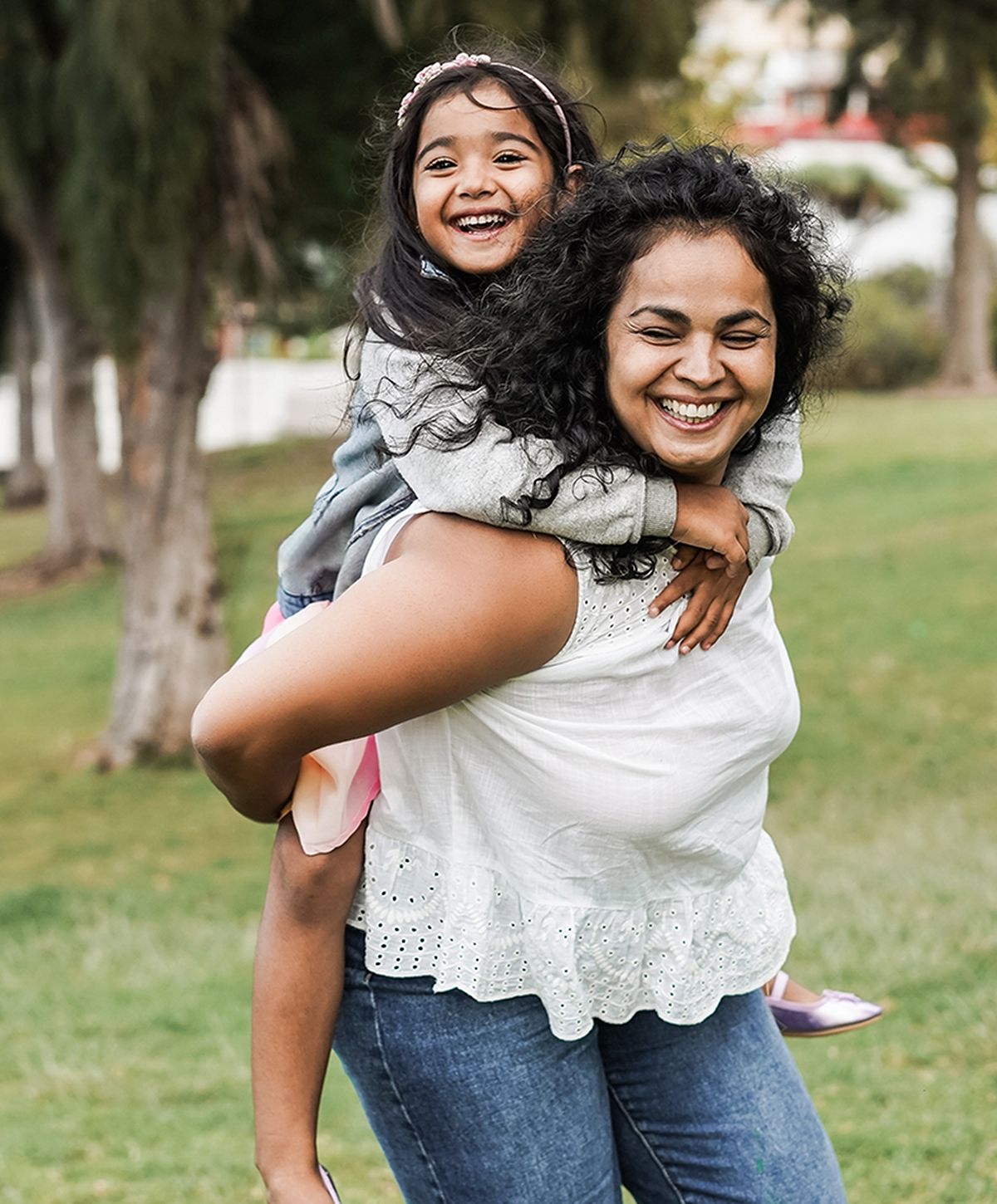 Mother and daughter enjoying a fun moment outdoors.
